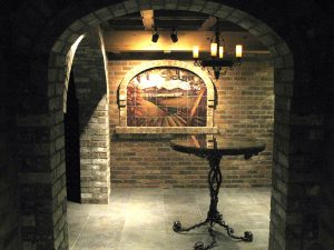 Tumbled marble tile mural on wall in wine cellar