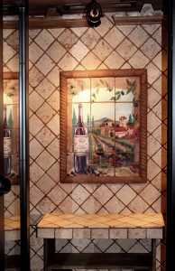 Tumbled marble tile mural on wall in wine cellar