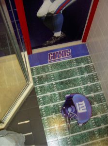 Glass floor tiles with image of football field on glass tiles for a bathroom floor