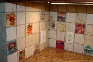 wine labels transferred onto marble tiles to create tile backsplash